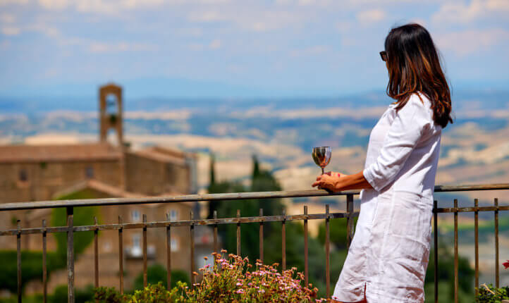 woman on balcony with wine