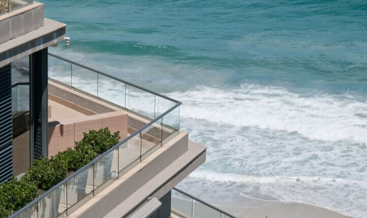 An investment property overseas with a balcony that looks over the sea.